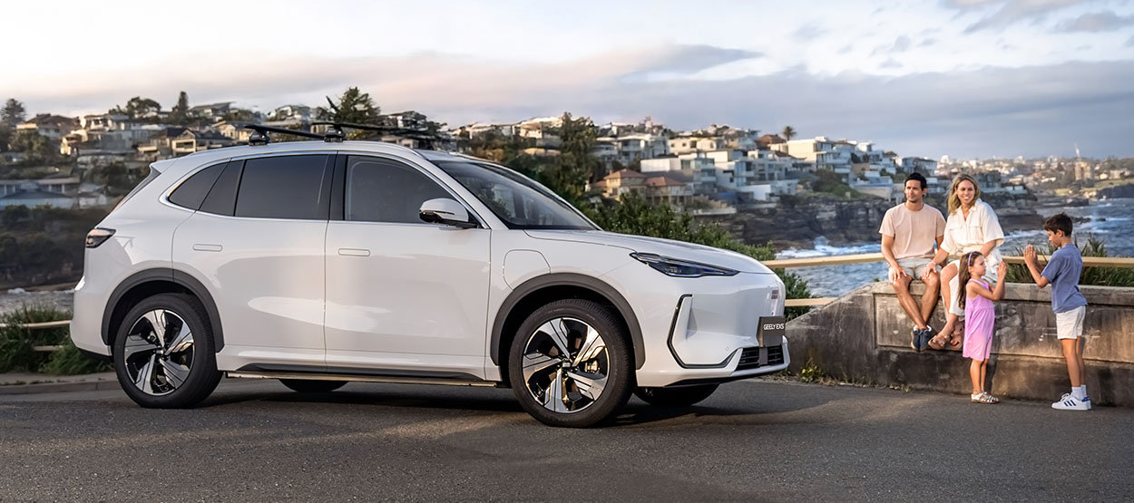 White Geely SUV next to a family