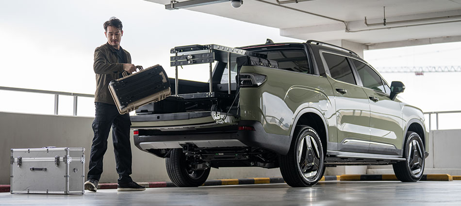 A man loading equipment into the tray of a Riddara ute